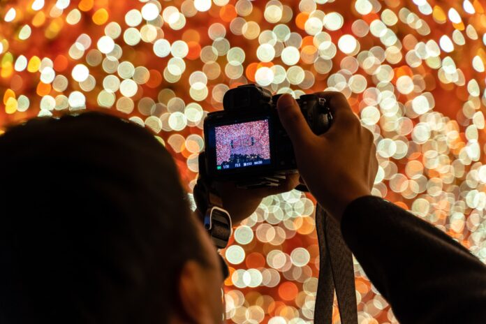 person taking photo of lights for church social media in December
