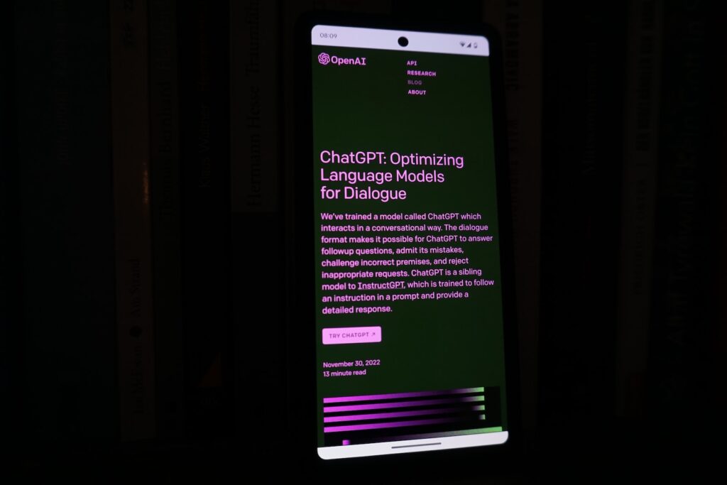 Revolutionize Your Ministry with ChatGPT: 12 Ways Your Church Can Use ChatGPT 1 a cell phone with a lit up screen in the dark with ChatGPT