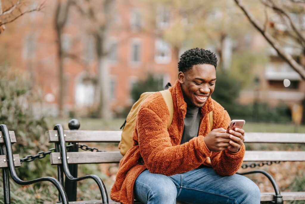 young man getting a text message from church