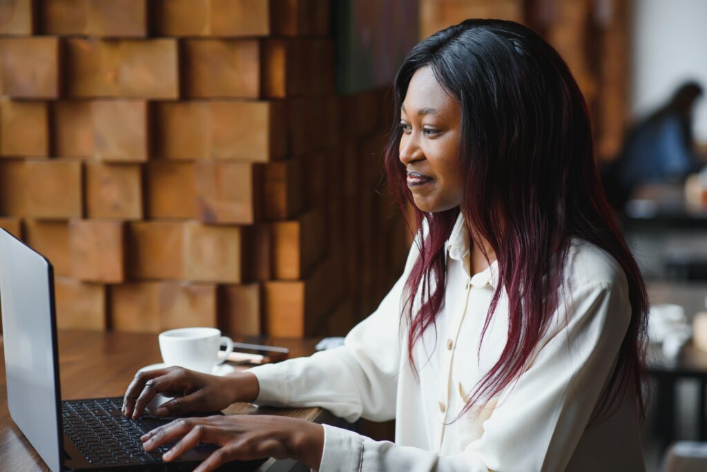 happy african american woman worker using laptop w 2023 12 01 00 34 26 utc