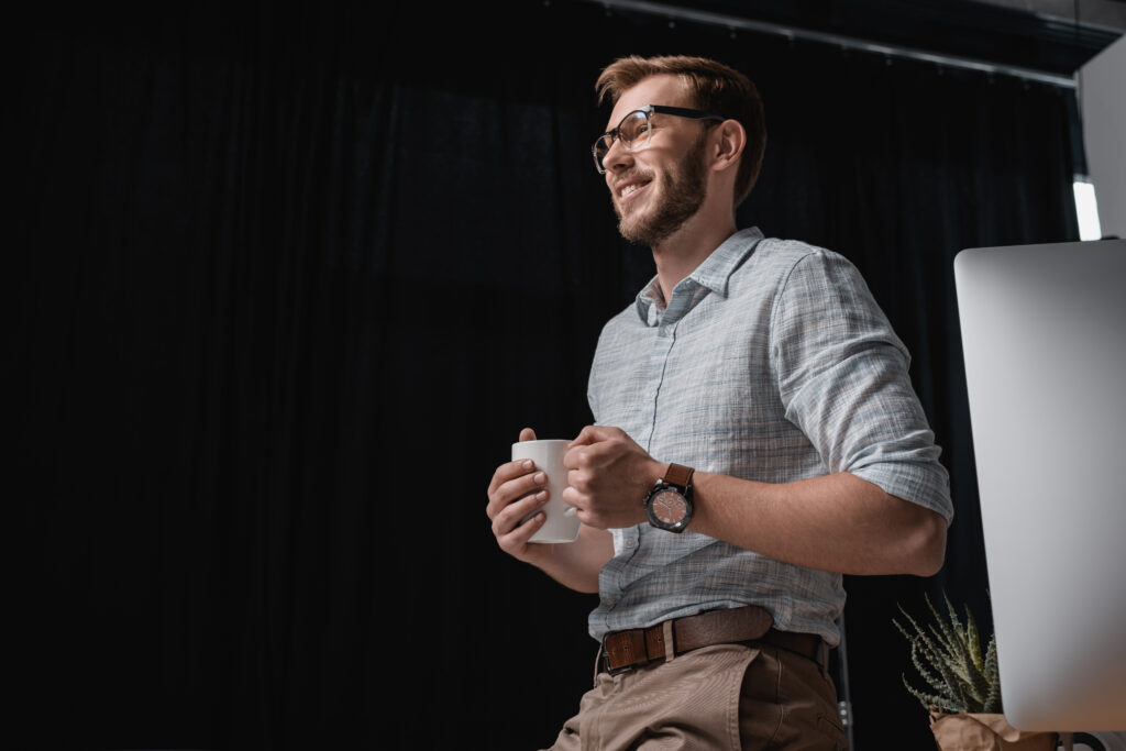 smiling caucasian businessman holding coffee cup a 2023 11 27 05 05 55 utc