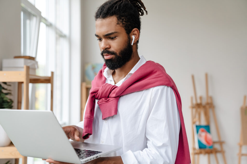 serious african american guy in earphones working 2023 11 27 04 54 25 utc