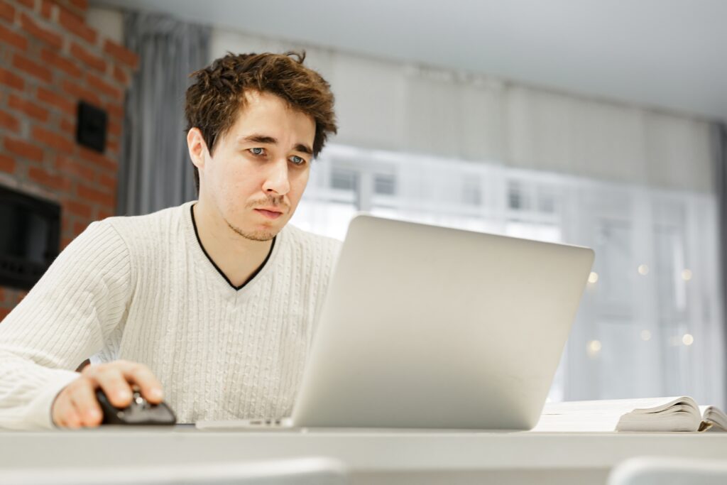 man using laptop while sitting at home at table f 2023 11 27 05 27 22 utc