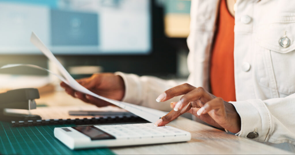 calculator hands and paperwork on desk office an 2024 07 11 22 51 40 utc