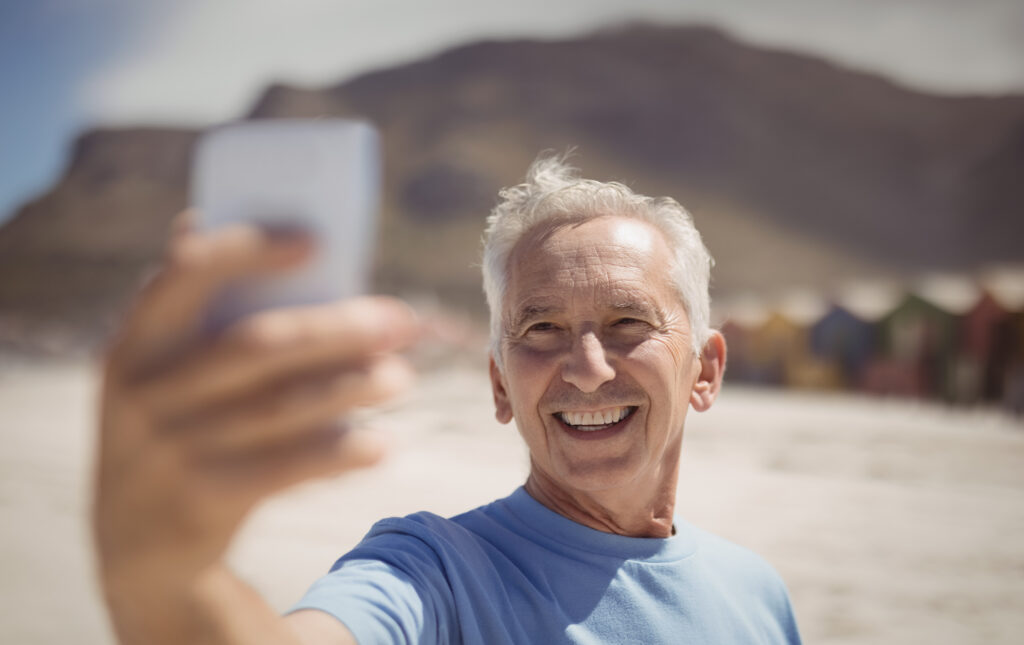 happy senior man taking selfie at beach 2023 11 27 05 05 44 utc