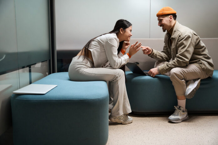 Smiling people on a couch, learning how to repurpose content effectively.